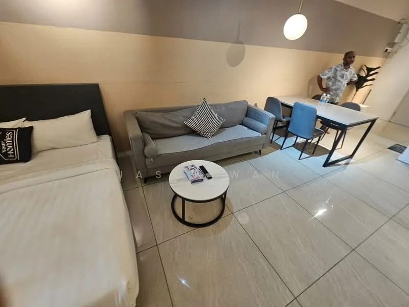 Living features: queen-size bed with white bedding, grey fabric sofa, round white coffee table, 4-seater dining table with blue chairs, marble tile flooring, wall-mounted light fixture, decorative cushion on sofa, neutral painted walls; style: modern.