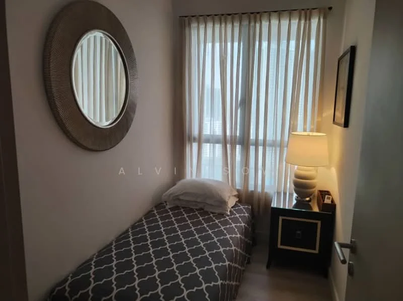 Bedroom features: single bed with white bedding, grey patterned bedspread, nightstand with drawer, table lamp with white shade, round mirror on wall, floor-to-ceiling window with sheer curtains, light wood flooring, wall-mounted artwork; style: modern.