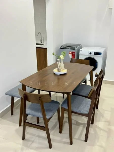 Dining features: wooden dining table, 4 dining chairs with grey upholstery, decorative vase on table, light-colored tiled flooring, laundry machine visible in background, kitchen area visible in background, sink visible in kitchen area; style: modern.