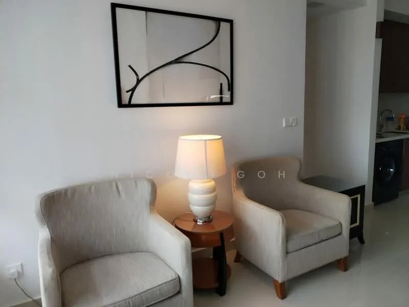 Living features: two beige upholstered armchairs, round wooden side table, table lamp with white shade, framed abstract artwork on wall, white painted walls, glossy tile flooring, recessed ceiling lights; style: modern.
