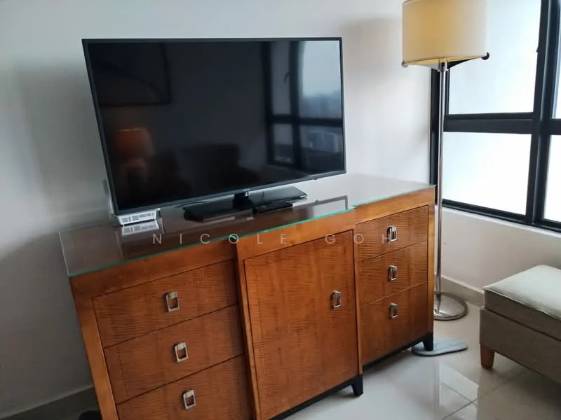 Room features: flat-screen TV on console, wooden console with glass top, multiple drawers on console, lamp with fabric shade, neutral-colored armchair, large windows with black frames, light-colored flooring, minimalist decor; style: modern.