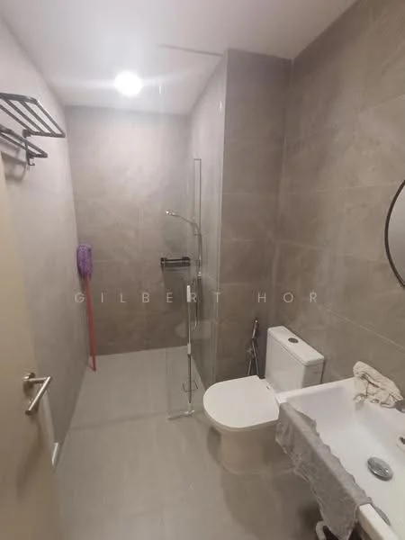 Bathroom features: grey tiled walls, light grey tiled flooring, walk-in shower with glass enclosure, rain shower head, handheld shower, one-piece toilet, framed mirror, vanity with countertop, ceiling light, towel rack, cleaning mop, white shower curtain; style: modern.