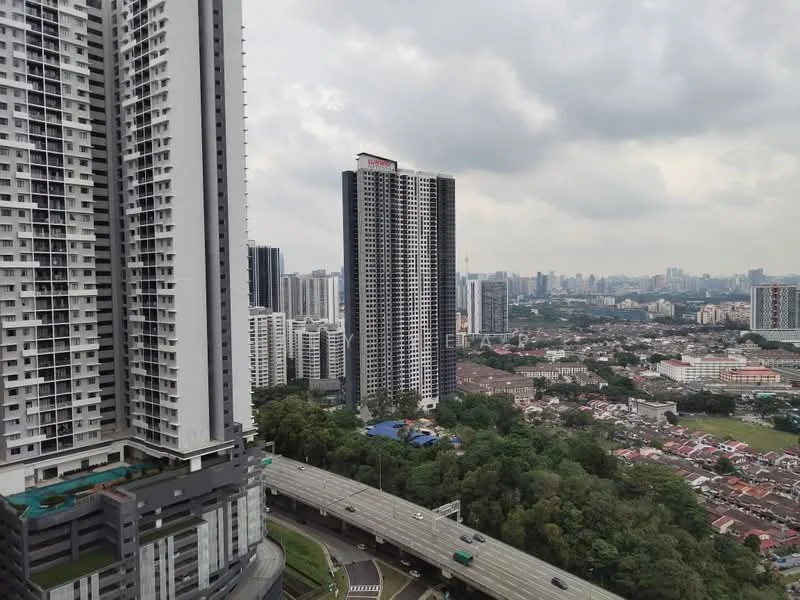 Exterior type: high-rise condominium; features: glass curtain wall, recessed balconies, surrounded by greenery, urban skyline view, multiple high-rise buildings, near highway, landscaped grounds; style: modern.
