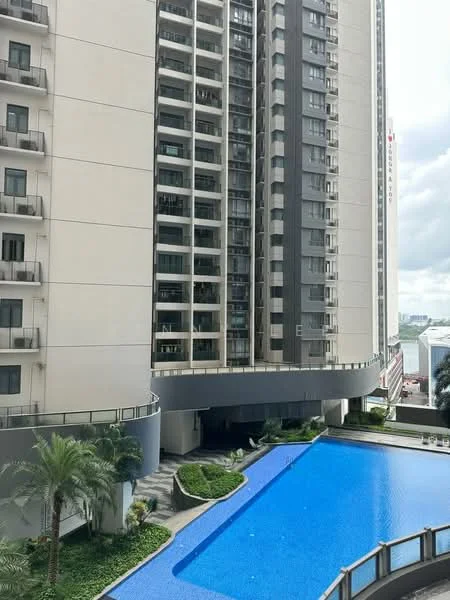 Exterior type: high-rise condominium; features: glass curtain wall facade, recessed balconies, infinity pool, pool deck with loungers, manicured landscaping, palm trees, stone-paved walkway, approximately 20-storey high-rise; style: modern.