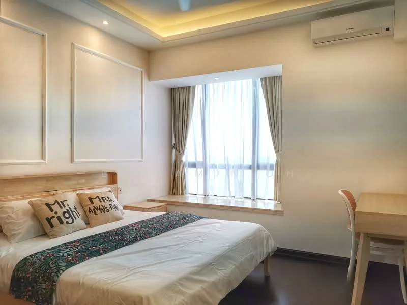 Bedroom features: king-size bed with white bedding, upholstered headboard, two decorative pillows with text, wooden bedside table, window with sheer curtains, built-in window seat, light wood flooring, recessed ceiling lights, wall-mounted air conditioning unit, study desk with chair; style: modern.