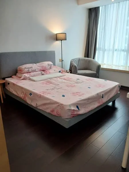 Bedroom features: king-size bed with patterned bedding, upholstered headboard, wooden bed frame, floor-to-ceiling window with sheer curtains, grey armchair, lampshade floor lamp, dark wood flooring, decorative wall with light color, nightstand with lamp; style: modern.