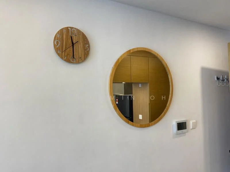 Room features: white painted walls, round mirror with wooden frame, wooden wall clock, wall-mounted thermostat, light switch; style: modern.