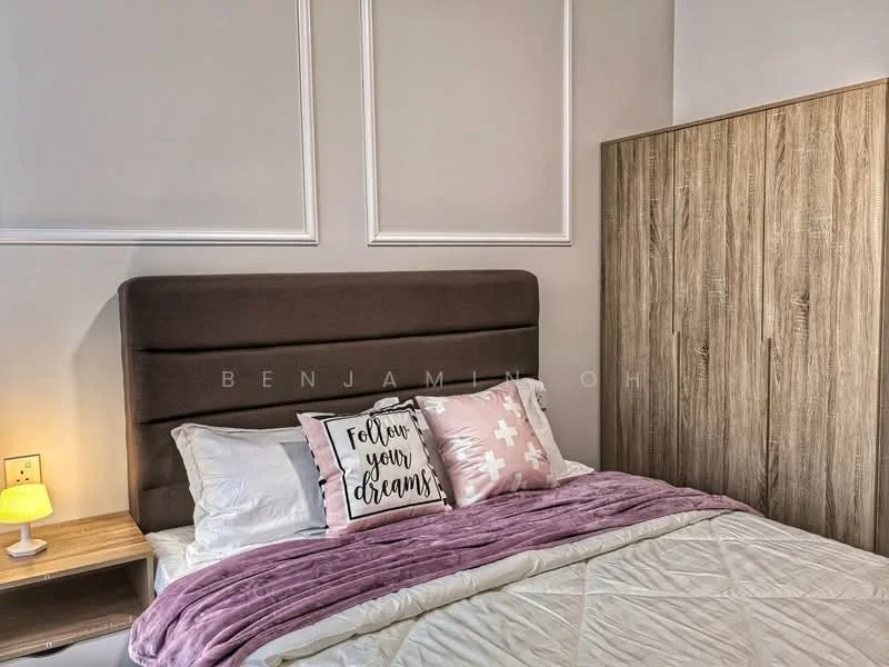 Bedroom features: king-size bed with upholstered headboard, white bedding with decorative pillows, purple throw blanket, nightstand with lamp, wooden wardrobe, white painted walls, crown moulding, decorative wall paneling, framed wall art with text; style: modern.