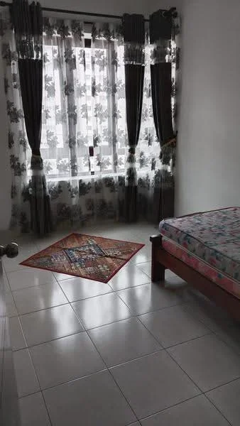 Bedroom features: single bed, floral patterned bedspread, white walls, tiled flooring, curtains with floral pattern, area rug with geometric pattern, window with sheer curtains, wooden bed frame.