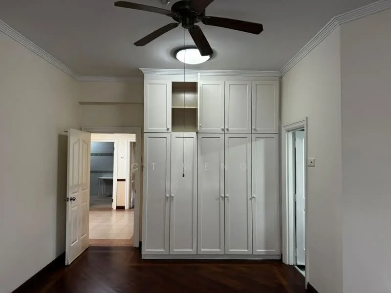Room features: wooden flooring, white painted walls, ceiling fan with light, built-in wardrobe with multiple doors, doorway leading to another room, doorway leading to kitchen area, crown moulding.