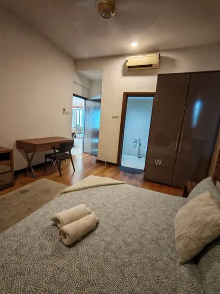 Bedroom features: wooden flooring, white painted walls, ceiling fan, built-in wardrobe with sliding doors, study desk with chair, bed with decorative pillows, towels on the bed, window with natural light, doorway leading to bathroom, light fixture on ceiling; style: modern.