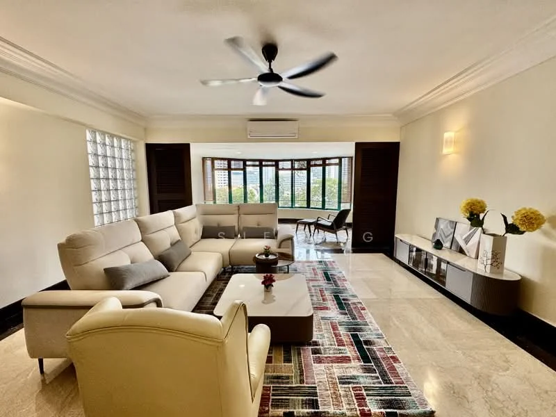 Living features: 3-seater fabric sofa in cream, 2-seater armchair in cream, coffee table with glass top, area rug with geometric pattern, marble flooring, ceiling fan with 5 blades, wall-mounted TV console, decorative wall art, large windows with garden view, recessed lighting, white painted walls, crown moulding; style: modern; view: garden.