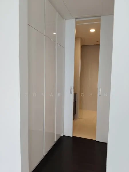 Room features: white high-gloss cabinetry, sliding doors, dark wood flooring, recessed ceiling lights, neutral wall color, minimalist design, open space, modern aesthetic; style: modern.