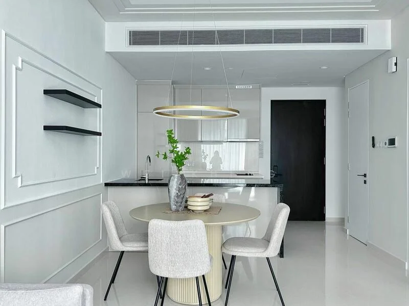 Dining features: round dining table, 4 upholstered dining chairs, pendant light fixture, white walls with decorative moulding, glossy tile flooring, black countertop, built-in cabinetry, green plant in vase; style: modern. Kitchen features: white cabinetry, black countertop, built-in oven, stainless-steel sink, chrome faucet, recessed lighting, open shelving; style: modern.