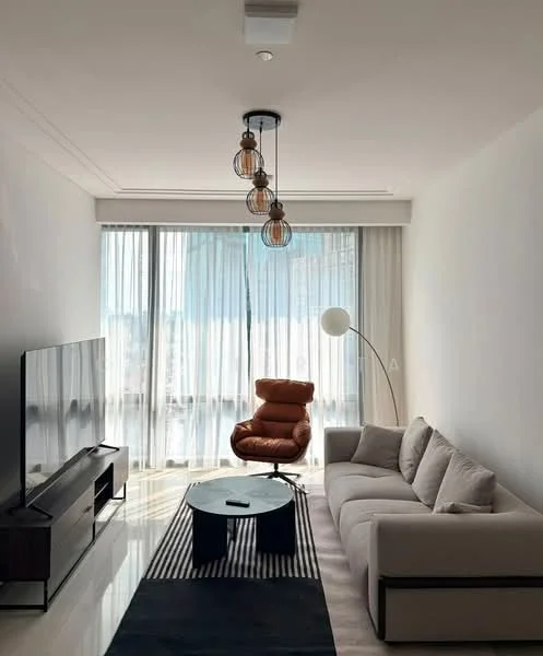 Living features: 3-seater fabric sofa in light grey, round coffee table, floor lamp with white shade, TV console with wall-mounted TV, large floor-to-ceiling windows, sheer curtains, chandelier with three pendant lights, black area rug with geometric pattern, accent chair in brown leather, polished tile flooring, white painted walls, crown moulding; style: modern; view: city.