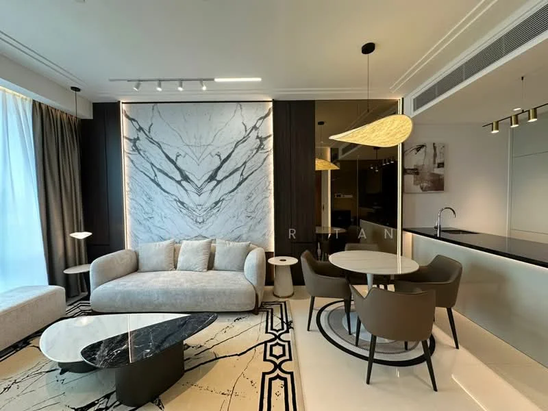 Living features: light grey fabric sofa, black marble coffee table, area rug with geometric pattern, floor-to-ceiling windows with sheer curtains, recessed downlights, pendant light fixture, decorative wall with marble finish, wall-mounted TV, open-plan layout with dining area; style: modern. Dining features: round dining table, upholstered dining chairs in brown, pendant light above dining table, kitchenette visible in background; style: modern.