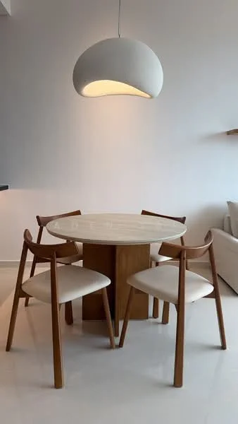 Dining features: round dining table with marble top, wooden base for dining table, 4 upholstered dining chairs in cream, pendant lamp with a curved design, white painted walls, polished tile flooring; style: modern.