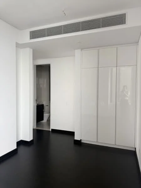 Room features: white painted walls, black vinyl plank flooring, built-in white cabinetry, recessed ceiling lights, air conditioning vent, doorway leading to bathroom, no visible windows; style: modern.