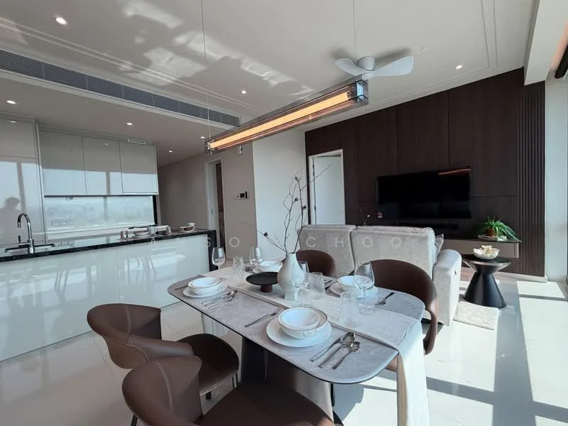 Dining features: 6-seater dining table, upholstered dining chairs in brown, white tablecloth, decorative vase on table, cutlery and glassware set on table, pendant light fixture above table, large window with city view, light-colored flooring, wall-mounted TV, dark wood accent wall, open kitchen area visible in background, recessed ceiling lights; style: modern; view: city. Kitchen features: kitchen island with bar seating, stainless-steel appliances, white cabinetry, black countertop, built-in oven, induction cooktop, refrigerator, sink with faucet, open shelving, backlit cabinetry; style: modern.