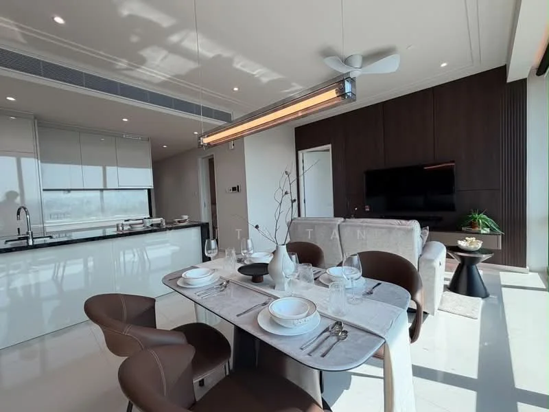 Dining features: 6-seater dining table, upholstered dining chairs in brown, table setting with plates and cutlery, decorative vase on table, pendant light fixture, floor-to-ceiling windows, neutral wall color, marble flooring; style: modern; view: city. Kitchen features: kitchen island with seating, stainless-steel sink, built-in oven, stainless-steel range hood, white cabinetry, black countertop, recessed downlights; style: modern. Living features: wall-mounted TV, black entertainment unit, sofa, decorative plant, neutral wall color, large windows, natural light; style: modern; view: city.