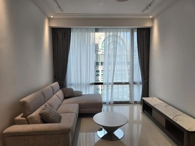 Living features: L-shape sectional sofa in beige, coffee table with round top, marble TV console, floor-to-ceiling windows, sheer curtains, grey drapes, glossy tile flooring, recessed downlights, decorative wall with minimal design; style: modern; view: city.