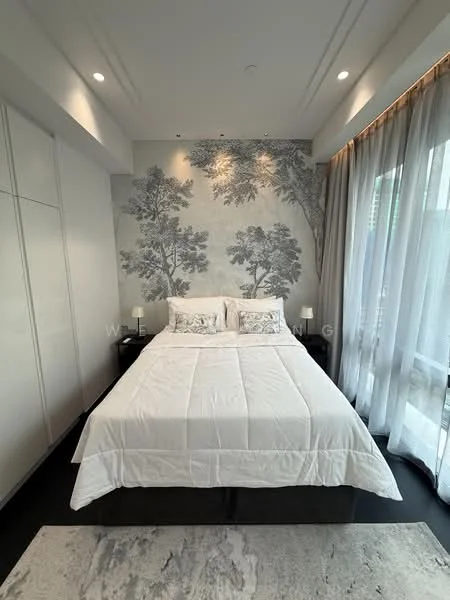 Bedroom features: king-size bed with white bedding, decorative pillows, wall mural with tree design, floor-to-ceiling windows, sheer curtains, black bedside tables, table lamps on bedside tables, built-in wardrobe with sliding doors, dark wood flooring, recessed downlights, crown moulding on ceiling; style: modern.