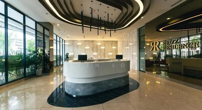 Lobby features: marble flooring, reception desk with curved design, hanging pendant lights, floor-to-ceiling windows, greenery with potted plants, decorative wall with logo, sofa seating area, modern ceiling design with wood accents; style: modern; view: garden.