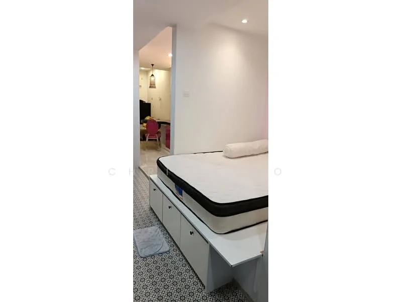 Bedroom features: queen-size bed, mattress on bed frame, built-in storage drawers under bed, decorative area rug, white painted walls, recessed downlights, flooring with patterned tiles, open doorway leading to another room; style: modern.