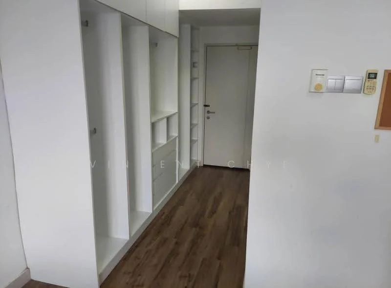 Room features: white painted walls, laminate flooring, built-in shelving units, white cabinetry, door with metal handle, light switch panel, intercom panel, wall-mounted thermostat; style: modern.