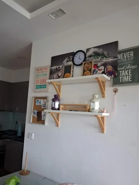 Room features: white painted walls, light wood shelving, decorative wall clock, framed artwork, wall-mounted photo displays, kitchen area visible in background, open shelving, decorative items on shelves; style: modern.