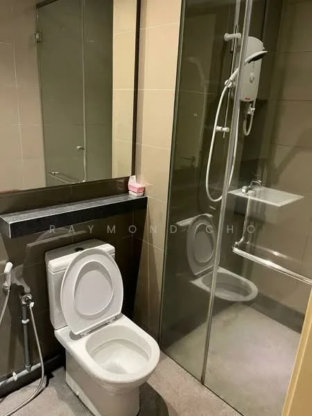 Bathroom features: one-piece toilet, glass shower enclosure, wall-mounted shower head, built-in sink, mirror above sink, grey tiled walls, dark countertop, light grey flooring, water heater, chrome faucet; style: modern.