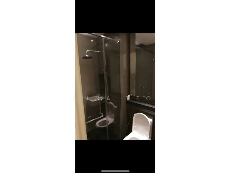Bathroom features: walk-in shower with glass enclosure, rain shower head, handheld shower, white toilet, black tile flooring, dark wall tiles, vanity with sink, mirror above vanity, recessed downlights; style: modern.