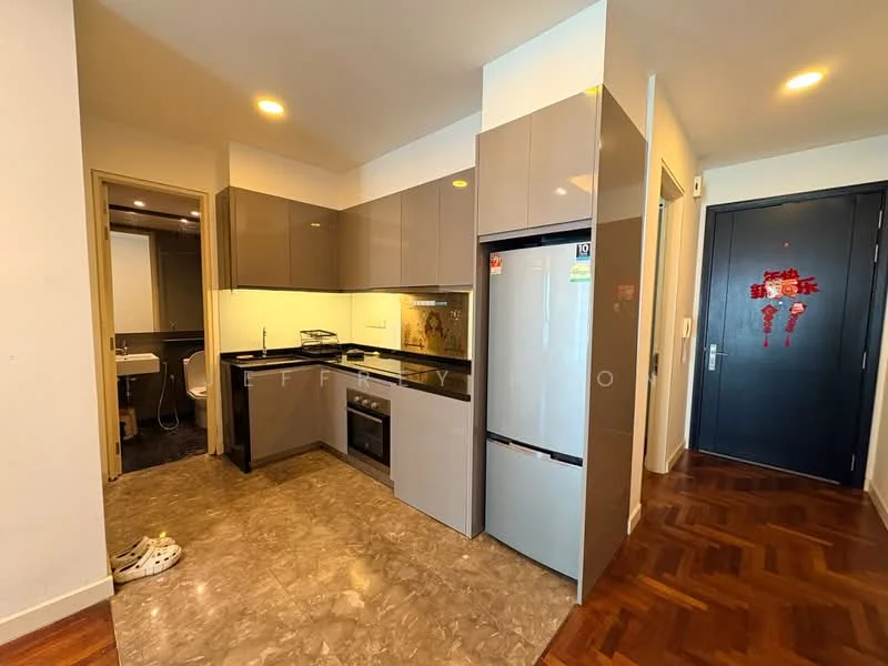 Kitchen features: grey flat-panel cabinets, black countertop, stainless-steel fridge, built-in oven, ceramic cooktop, single-bowl stainless-steel sink, chrome pull-down faucet, marble tile flooring, recessed downlights, open layout, wall-mounted microwave; style: modern. Room features: door leading to bathroom, wooden door, light-colored walls, brown parquet flooring.