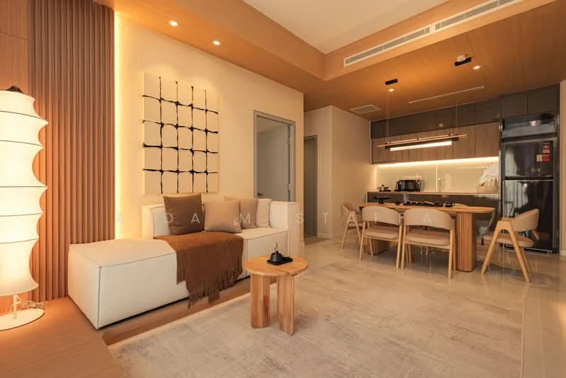 Living features: light wood panelled ceiling, cream painted walls, large sectional sofa in white, brown throw blanket on sofa, wooden side table, floor lamp with white shade, framed artwork on wall, dining table with four wooden chairs, black refrigerator, built-in cabinetry with under-cabinet lighting, ceramic tile flooring, recessed LED downlights; style: modern.