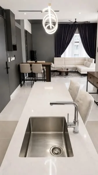 Kitchen features: single-bowl stainless-steel sink, chrome pull-down faucet, white marble countertop, pendant light fixture, bar stools, dark cabinetry, open layout, recessed downlights, grey accent wall, floor-to-ceiling windows with sheer curtains, polished tile flooring; style: modern. Living features: sectional sofa in light fabric, coffee table, TV console, area rug, dining table, dark wood furniture; style: modern.