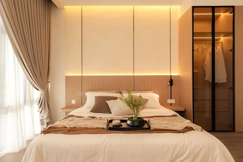 Bedroom features: king-size bed with beige bedding, upholstered headboard, wooden bedside table, decorative tray with plant, built-in wardrobe with glass doors, soft lighting with warm glow, floor-to-ceiling window with sheer curtains, textured wall panels, neutral color palette, laminate flooring; style: modern.