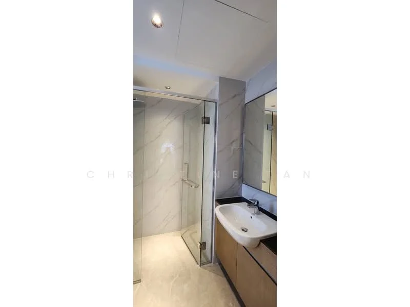 Bathroom features: walk-in shower with glass enclosure, chrome handheld shower, single-sink vanity with wood cabinet, white ceramic sink, mirror above sink, marble wall cladding, tile flooring, recessed downlights; style: modern.