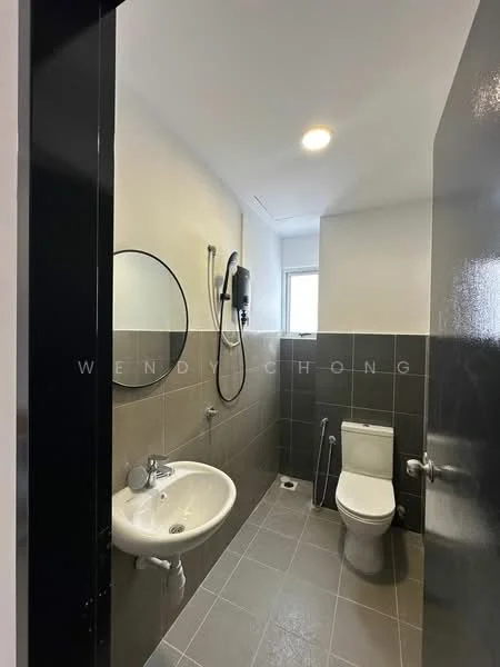 Bathroom features: grey tiled walls, white painted walls, grey tile flooring, round mirror, single-bowl sink, chrome basin mixer faucet, one-piece toilet, shower with handheld showerhead, window for natural light, wall-mounted water heater; style: modern.