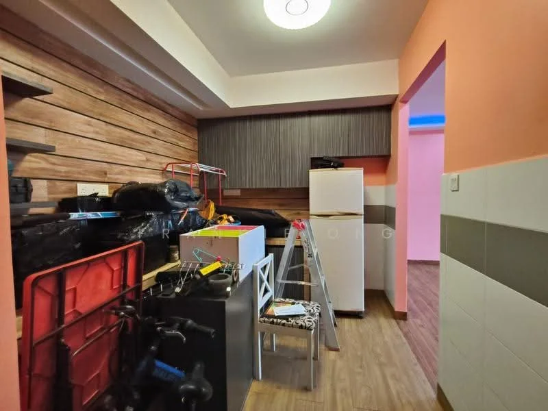 Room features: wood panelled walls, orange painted wall, grey cabinetry, white fridge, black shelving unit, wooden flooring, ladder, stacked boxes, white dining chairs, black table, various items stored; style: modern.