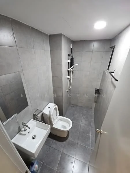 Bathroom features: grey tiled walls, grey tiled flooring, single-sink vanity with chrome faucet, one-piece toilet, framed mirror, shower with handheld shower head, wall-mounted shower control, towel rack, wall-mounted storage basket, recessed ceiling light; style: modern.