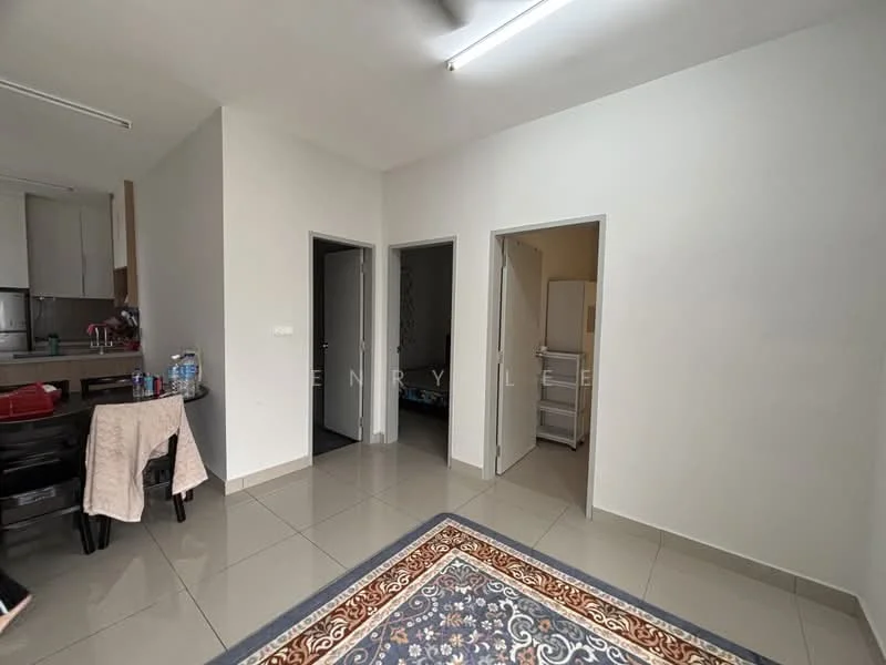 Room features: white painted walls, grey tiled flooring, ceiling lights, doorways leading to other rooms, area rug with decorative pattern, kitchenette area visible, open layout, refrigerator visible in adjacent room; style: modern.