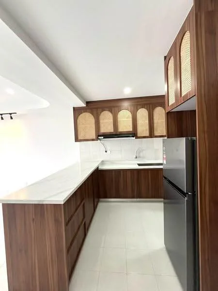 Kitchen features: wood cabinetry with glass inserts, white marble countertop, stainless-steel fridge, built-in oven, single-bowl stainless-steel sink, chrome pull-down faucet, white tiled backsplash, recessed downlights, light-colored tile flooring; style: modern.