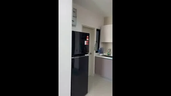 Kitchen features: black fridge, white cabinets, light-colored countertop, tile flooring, wall-mounted cabinet, door leading to another room, kitchen sink, kitchen utensils visible; style: modern.
