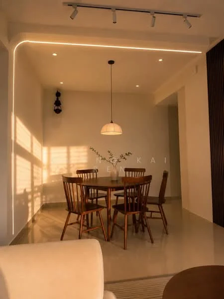 Dining features: round wooden dining table, 4 wooden dining chairs, pendant lamp with white shade, recessed LED downlights, wall-mounted decorative lighting, cream painted walls, polished tile flooring, decorative plant on table, natural light casting shadows; style: modern.