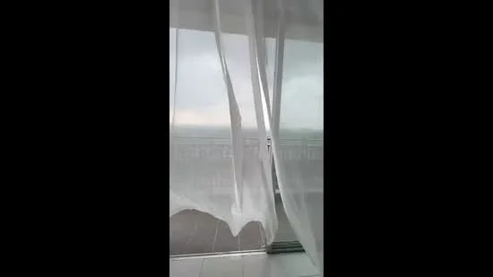 Room features: sheer curtains, floor-to-ceiling windows, tile flooring, balcony view; view: city.