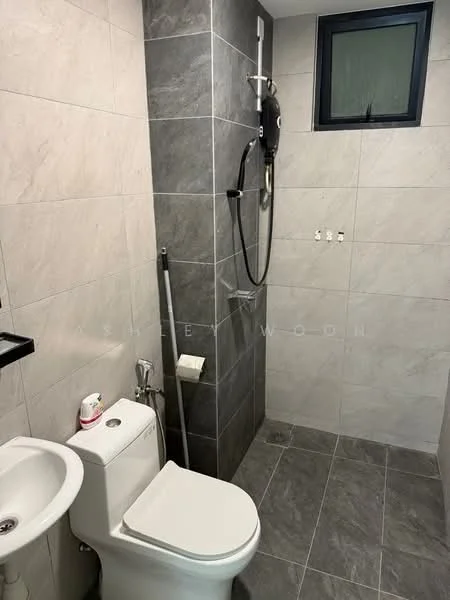 Bathroom features: grey ceramic tile flooring, light grey wall tiles, dark grey accent wall, one-piece toilet, chrome basin mixer faucet, shower with handheld shower head, shower wall with tile cladding, small window, toilet paper holder, soap dispenser; style: modern.