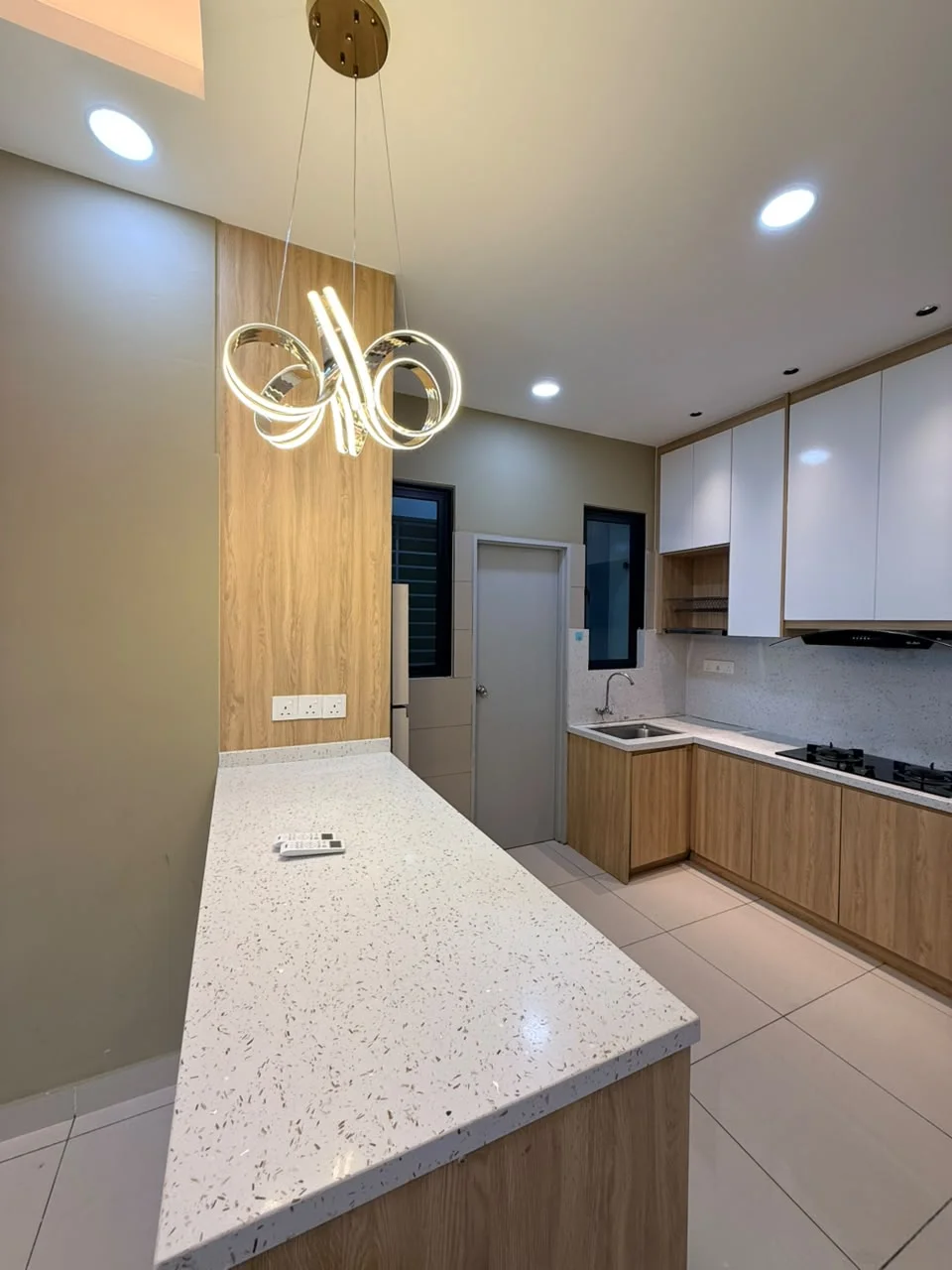 Kitchen features: white quartz countertop, wood cabinetry, stainless-steel sink, chrome pull-down faucet, built-in gas hob, built-in oven, pendant light fixture, tile flooring, cream painted walls, two windows, open layout, kitchen island with seating; style: modern.
