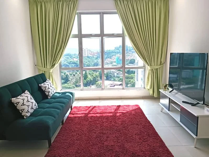 Living features: green fabric sofa, 4 decorative cushions, large floor-to-ceiling windows, green curtains, red area rug, white TV console, flat-screen TV, city view, tile flooring, natural light; style: modern; view: city.