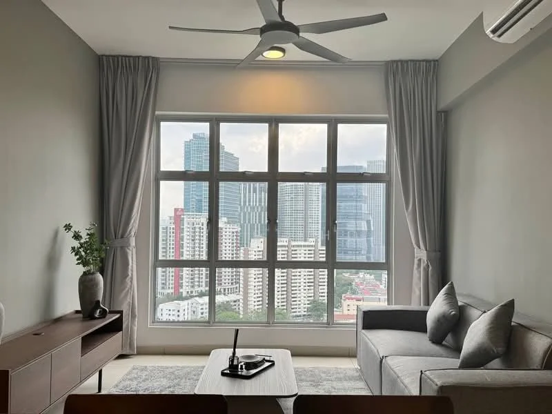 Living features: floor-to-ceiling windows, grey fabric sofa, wooden coffee table, light grey area rug, 3-blade ceiling fan, curtains in light grey, wall-mounted air conditioning unit, decorative vase with plant, TV console, city skyline view; style: modern; view: city.