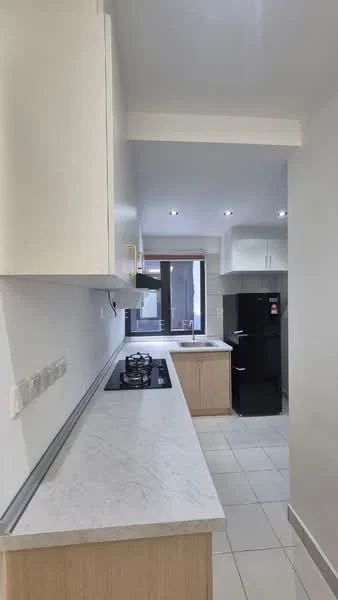 Kitchen features: white marble countertop, light wood cabinetry, built-in gas stove with 4 burners, black refrigerator, white tiled flooring, recessed downlights, window with natural light, sink with faucet; style: modern.